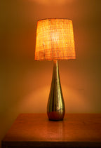 Mauri Almari Table lamp in plain brass and raphia shade, 1950