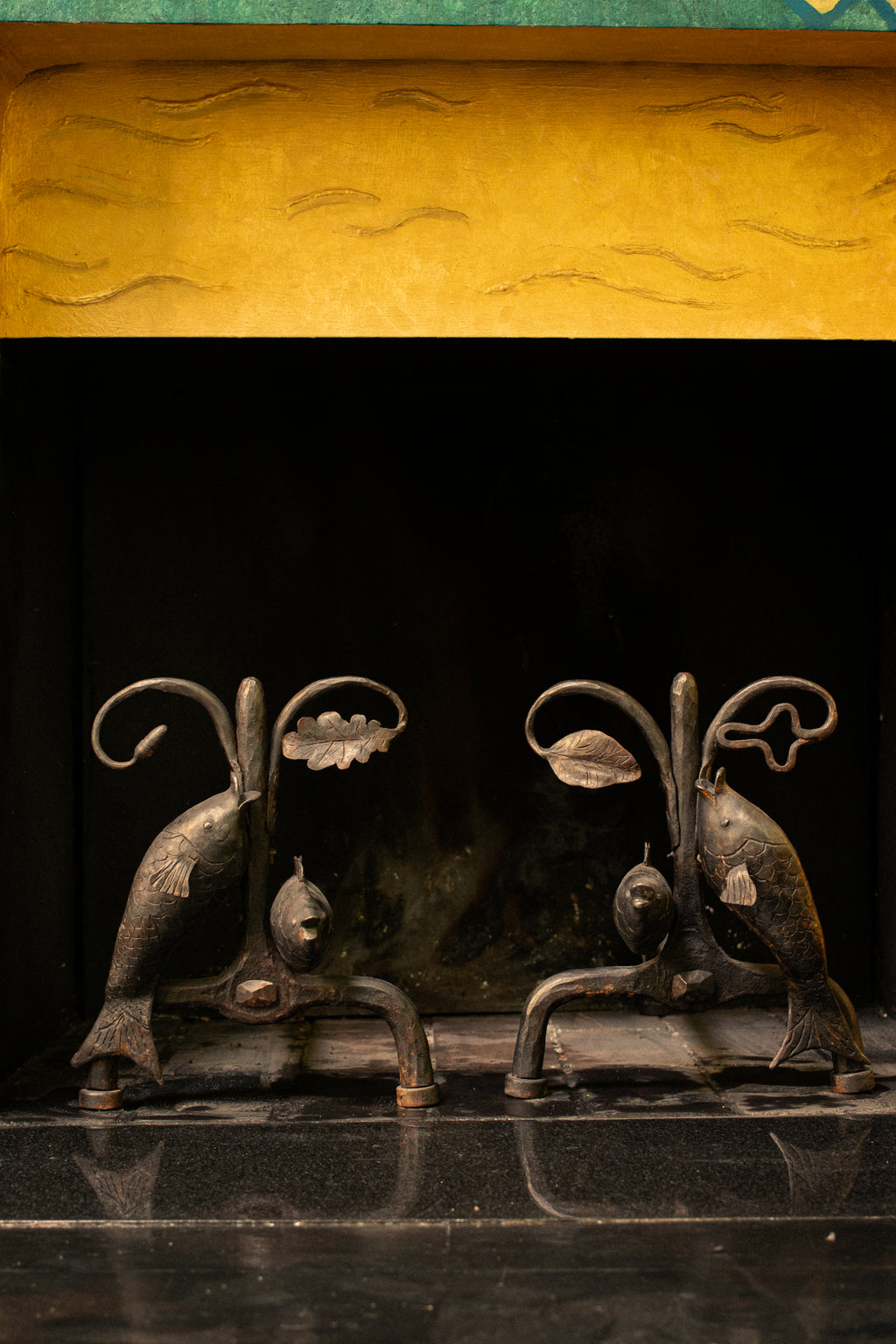 Andirons with oak leaves and fish, 1940
