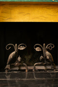 Andirons with oak leaves and fish, 1940