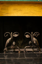 Andirons with oak leaves and fish, 1940